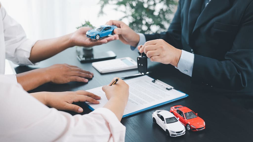 Car refinancing consultation reviewing loan terms and fees