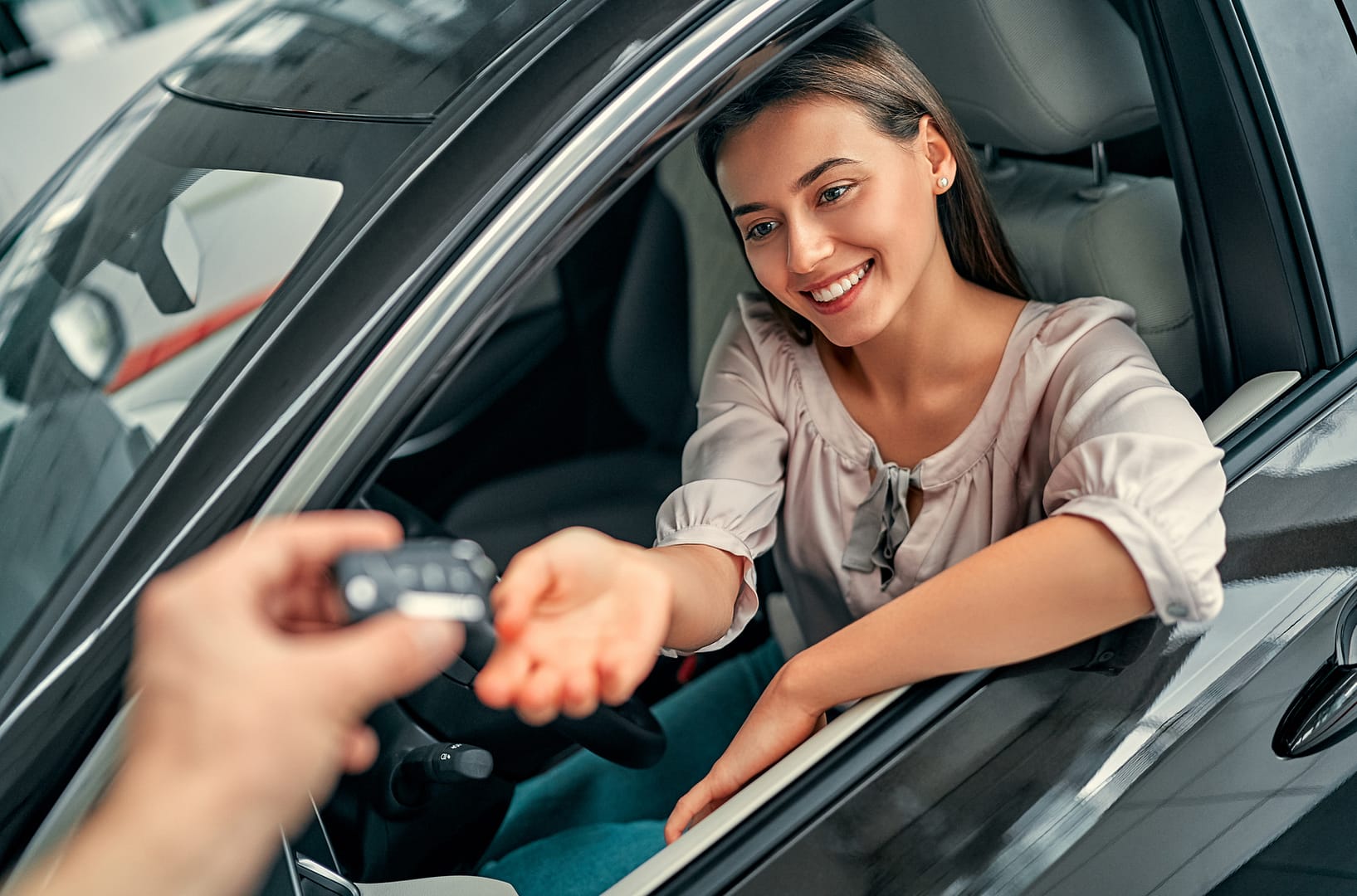 BYD Finance: How to Compare a Dealer Offer With a Broker-Arranged Car Loan 2 Driver receiving new car keys at a dealership, representing a new car finance decision
